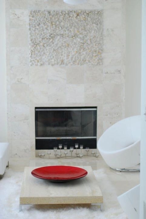 Minimalist bathroom with fireplace and oval tub